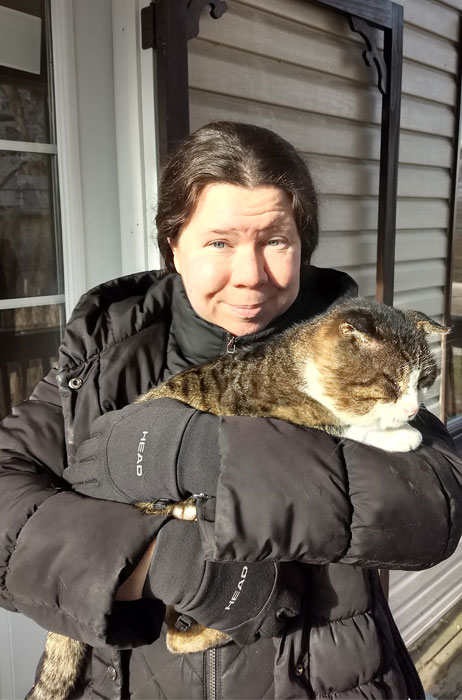 Photo of Samantha holding a tabby cat.
